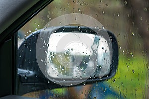 Rain drops on side window in a car close up