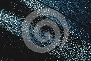 Rain drops on the surface of the car, abstract background