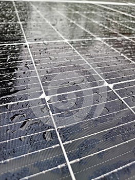 Rain drops on the surface of a solar panel on the roof