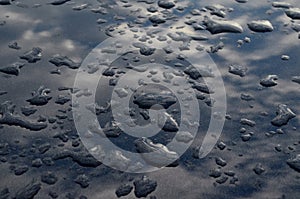 Rain drops on top of the dark car roof