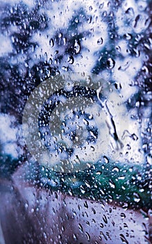 Rain drops water on car window background. surface out of glass window car with rain drop water in the raining day. Rainy Day.