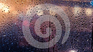 Rain drops on window Abstract traffic in raining day. View from car seat