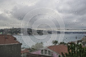 Rain drops on window against city view of Istanbul, Turkey