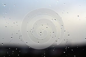 Rain drops on window with blured background