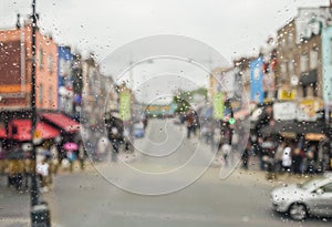 Rain drops on window. Blured colorful cityscape on a background.