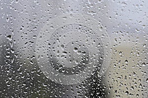 Rain drops on window glass background at rainy day blurred outside sky cloud blue texture - Image