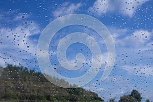 Rain drops window glass. Rainy day sky view through window