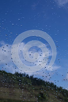 Rain drops window glass. Rainy day sky view through window