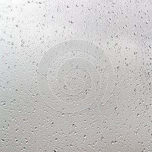 Rain drops on window pane in cloudy day