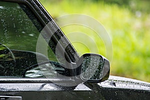 Rain drops on window and side mirror glass of the car, Abstract