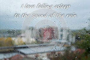 Rain drops on window with text `I love falling asleep to the sound of rain`