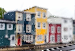 Rain drops on windows with jellybean houses in Newfoundland