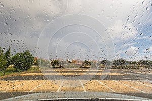 Rain drops on a windscreen in an empty car park