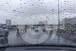 Rain drops on the windshield with driving a car