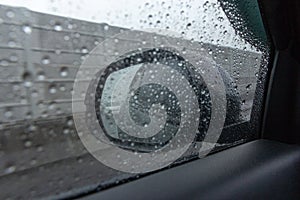 Rain drops on the windshield with driving a car on a road during rain