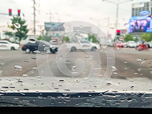 rain drops on the windshield traffic on a rainy day