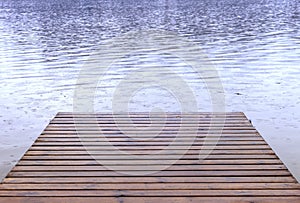 Rain falling on a boat launch dock and lake, spring summer weather and camping travel background