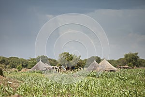 Rain falling near huts in south Sudan