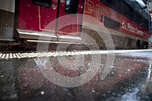 Rain falling on the station platform in front of a train