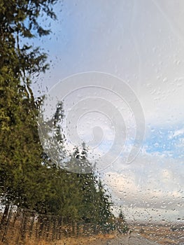 Rain falling on the windshield of the car