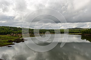 Rain filled monsoon clouds over a lake in India