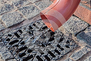 Rain flowing into a storm water sewer system.