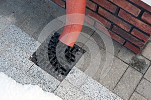 Rain flowing into a storm water sewer system.