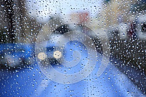 Rain on glass. Droplets of water beyond window glass during raining