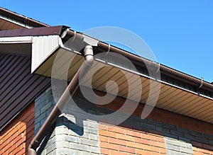 Rain gutter with downspout pipe. Home Guttering, Gutters, Plastic Guttering System.
