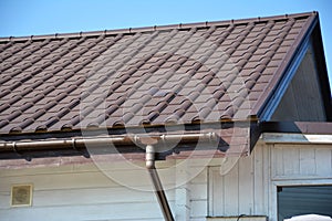 Rain gutter system. Metal roof with plastic roof guttering