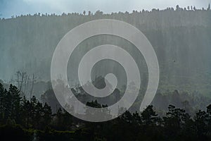 Rain over forest mountains. Misty mountain landscape hills at rainy day