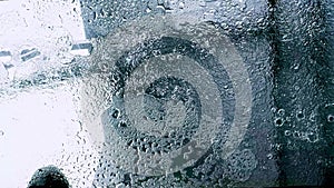 Rain pounding on glass roof window, rainstorm, rainy season.