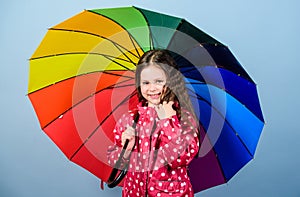 Rain protection. Rainbow. happy small girl with colorful umbrella. autumn fashion. Small girl in raincoat. cheerful