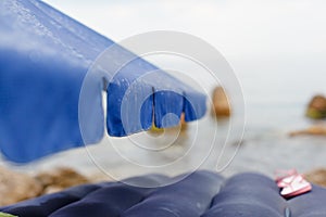 Rain raindrops flow down the beach umbrella