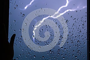 Rain. Raindrops on the window. Rainy day. Blue tone. Drops of water on the glass. Macro shooting. Texture