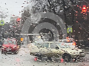 Rain on the road from car window, dangerous vehicle driving in rainy. Abstract blurred bad weather car, background