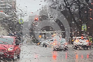 Rain on the road from car window, dangerous vehicle driving in rainy. Abstract blurred bad weather car, background