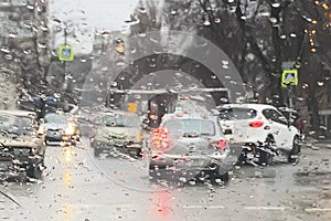 Rain on the road from car window, dangerous vehicle driving in rainy. Abstract blurred bad weather car, background