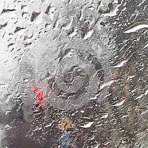 Rain on the road from car window, dangerous vehicle driving in rainy. Abstract blurred bad weather car, background