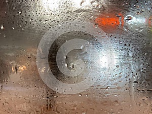 Rain on the road from car window, dangerous vehicle driving in rainy. Abstract blurred bad weather car, background