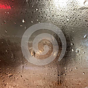 Rain on the road from car window, dangerous vehicle driving in rainy. Abstract blurred bad weather car, background