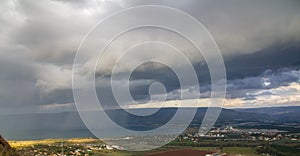 Rain Showers over the Sea of Galilee, Israel`s natural water sources, on a winter day with dramatic dark rain clouds scenery,