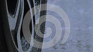 Rain splashing and car tire in rainwater. Car parking in the rain