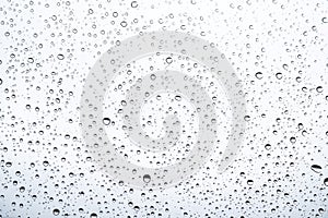 Of rain standing on a glass. water droplets on glass with white background photo