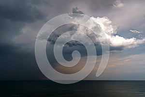 Rain and stormy cloud over sea