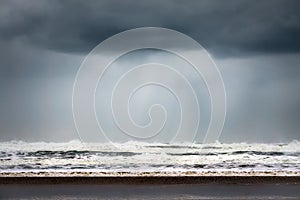 Rain and stormy cloud over sea