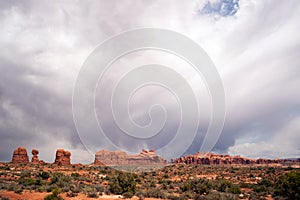 Rain Streaks Clouds Above Rock Formations Utah Juniper Trees