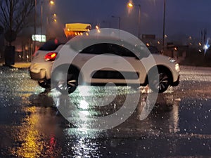 Rain street road in the night traffic lights of cars storm in winter