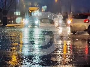 Rain street road in the night traffic lights of cars storm in winter