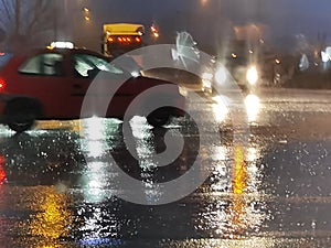 Rain street road in the night traffic lights of cars storm in winter